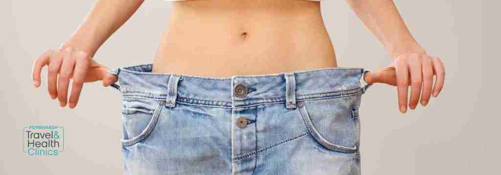 Successful weight loss displayed by big jeans